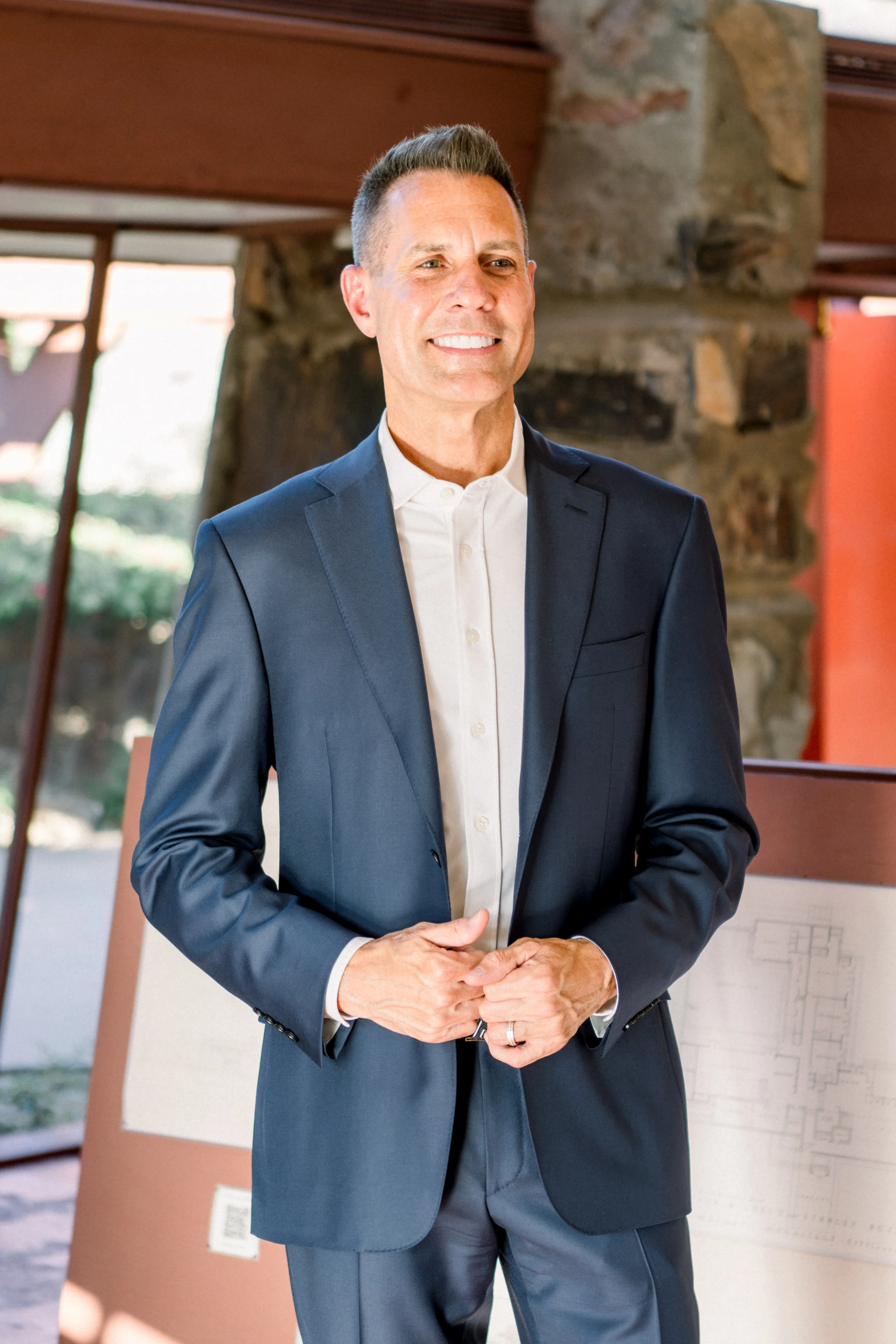 Smiling man in navy suit indoors