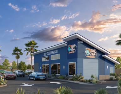 Modern blue car wash building at sunset