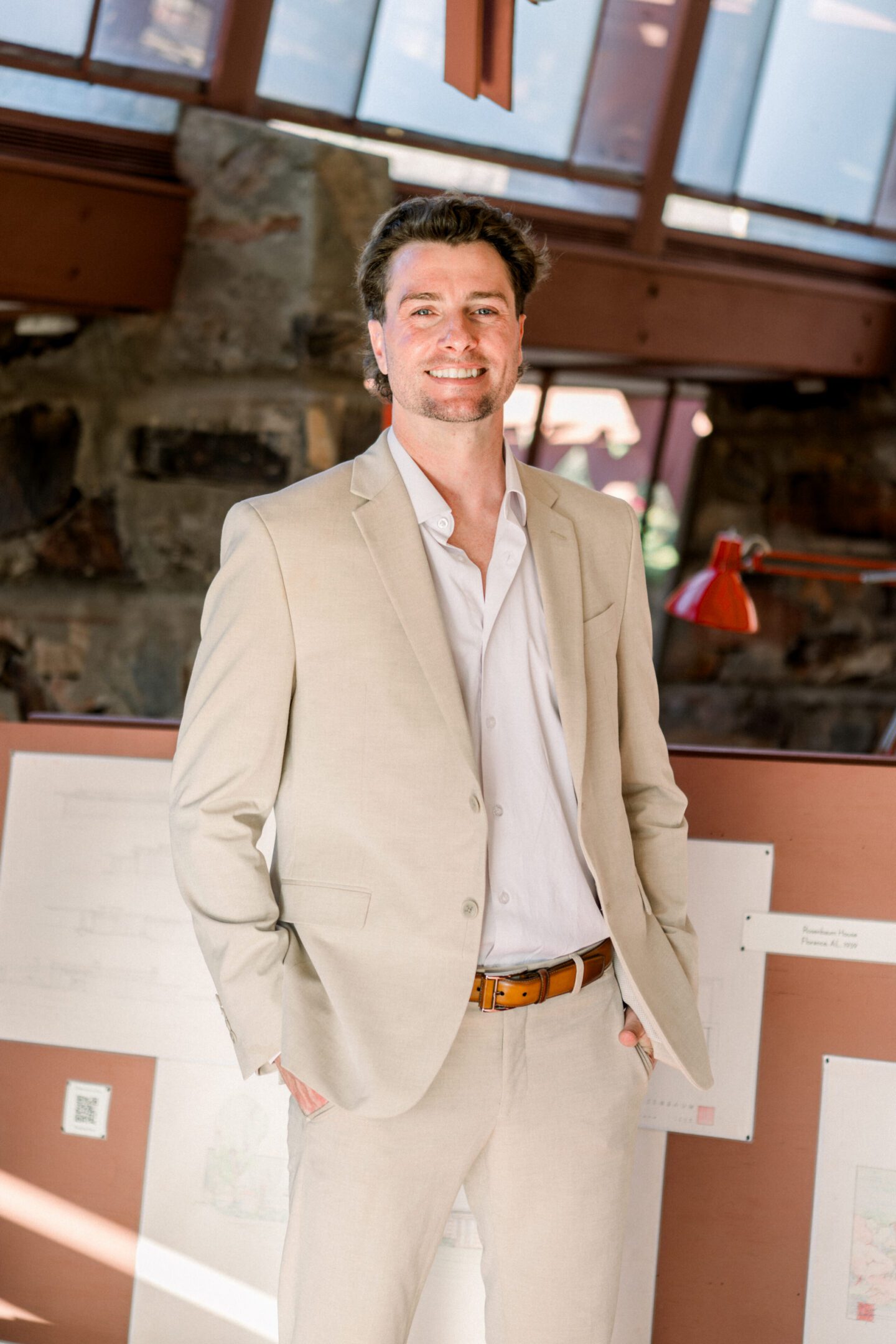Smiling man in beige suit, hands in pockets