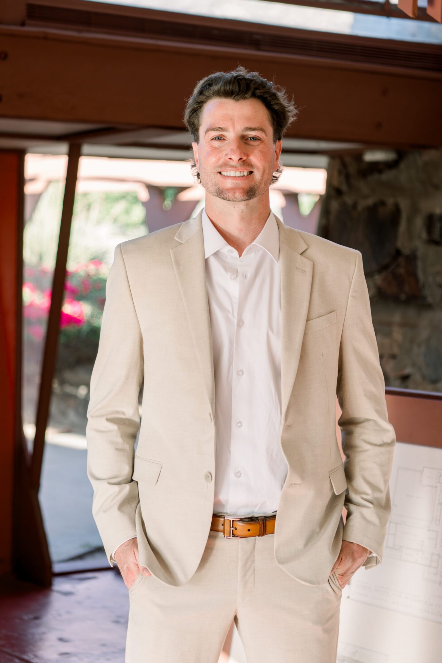 Smiling man in a beige suit