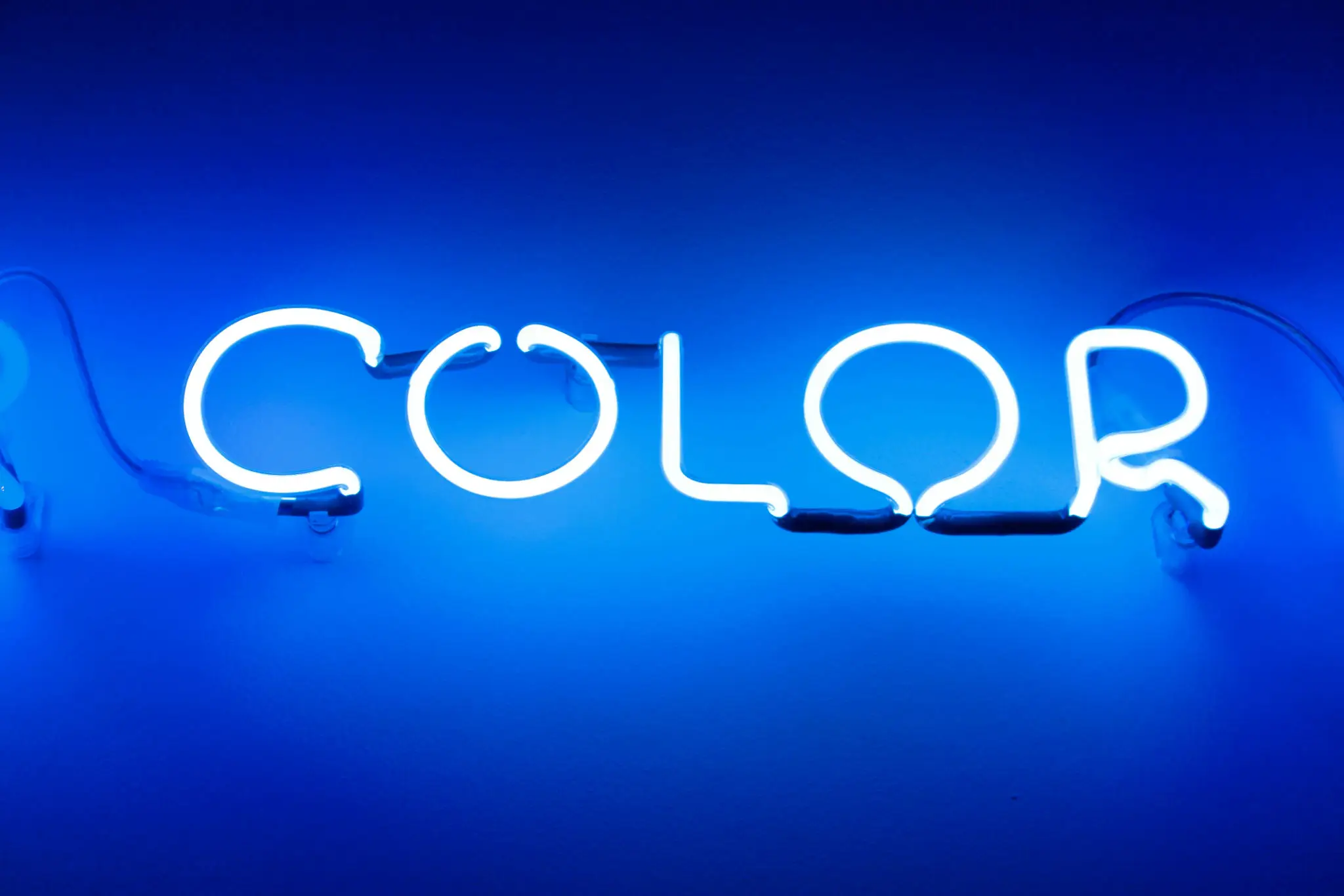Blue neon sign reading COLOR