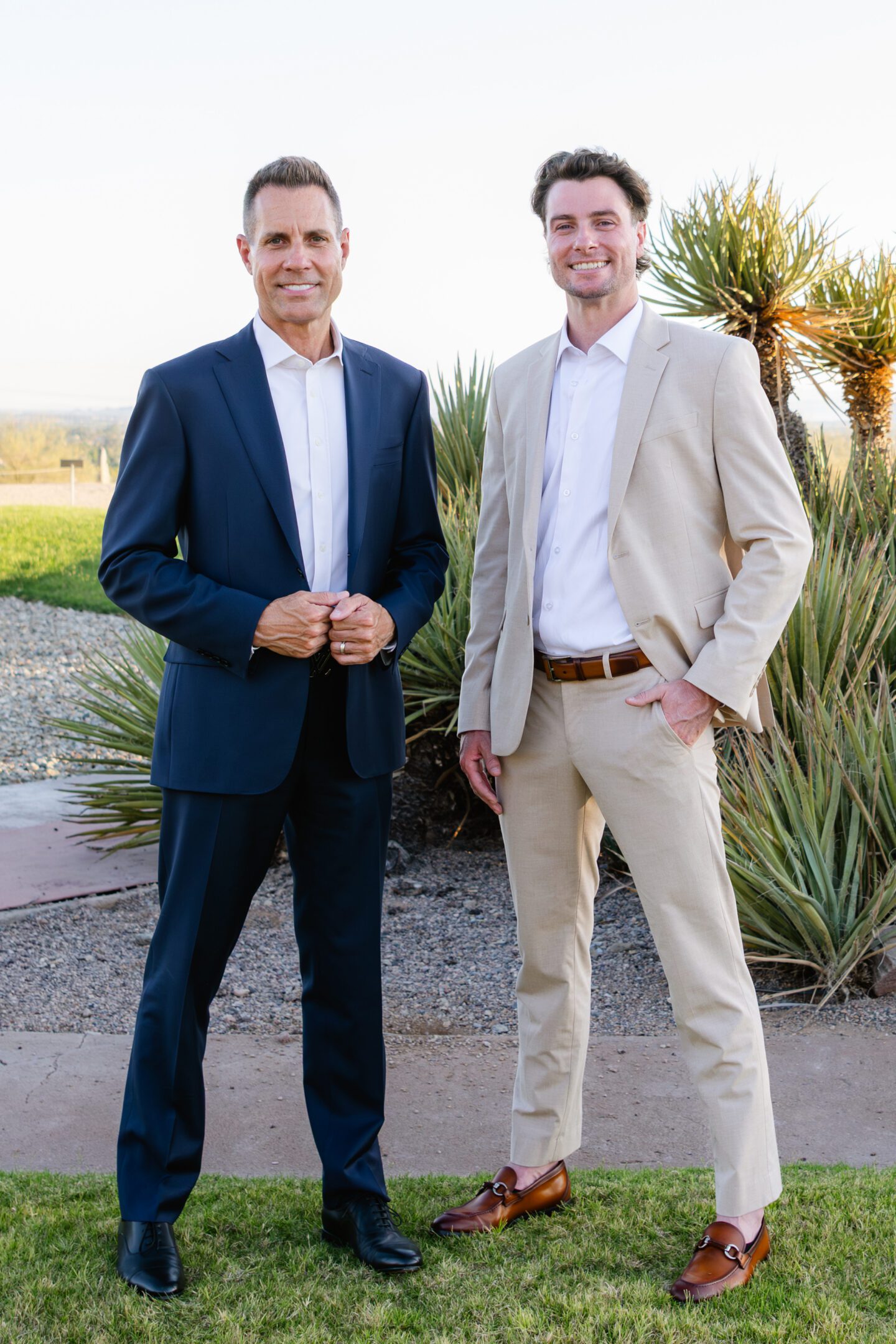 Two men in suits standing outdoors